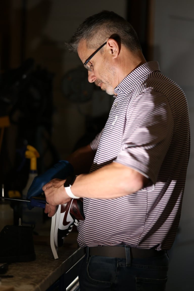 Craftsman working on leather repair in workshop